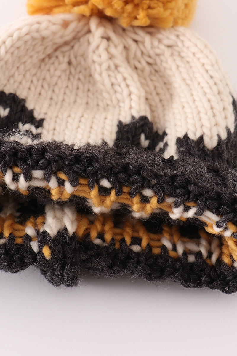 Black pompom dinosaur cable beanie